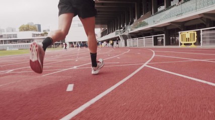 young man running on a track - Powered by Adobe