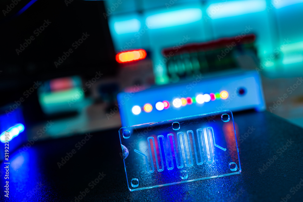 Wall mural microfluidic device Instrument that uses micro amounts of fluid on a microchip to do certain laboratory tests.