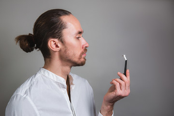 Puzzled manager with disposable razor on gray background