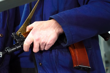 A security guards hand on a Kalashnikov. Armed departmental guards.
