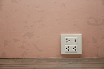 Plug Socket on the Wall with Pastel Background/Flower