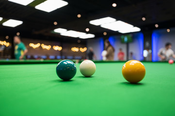 White , green and yellow snooker ball put on green flannel or velvet for ready to play snooker in the club.