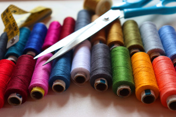 colorful spools of sewing thread on a white background