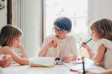 Mother of two children home schooling indoor