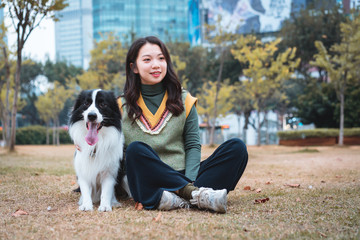 Young Aisa girl and her adult Border Collie 