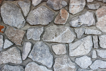 Stacked rough cut stone wall texture background