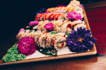A large set of Delicious sushi rolls view from above Flat Lay . A lot assortment Philadelphia roll Dishes from Japanese raw fish  in one plate in traditional restaurant. Copy Space Japan menu service