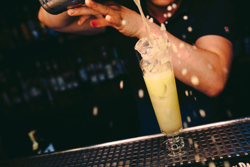 Bartender pouring using strainer White pink healthy Cocktail drink on a bar counter . Bartender view . Trendy stylish white. Copy paste for design people and luxury concept service barman in nightclub