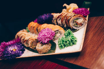 Fototapeta premium A large set of Delicious sushi rolls view from above Flat Lay . A lot assortment Philadelphia roll Dishes from Japanese raw fish in one plate in traditional restaurant. Copy Space Japan menu service