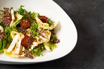 Baked Pumpkin salad with baked cheese, parsley herbs, white cabbage