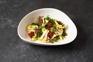 Baked Pumpkin salad with baked cheese, parsley herbs, white cabbage