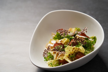 Baked Pumpkin salad with baked cheese, parsley herbs, white cabbage