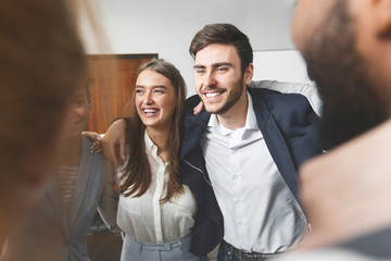 Teambuilding and unity. Colleagues embracing at business training