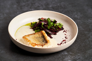 Fried fish perch with vegetables on a white table on grey table