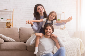 Happy family having fun and posing in living room at home