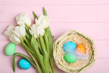 Easter eggs and flowers on the table top view. Easter composition with a place to insert text.