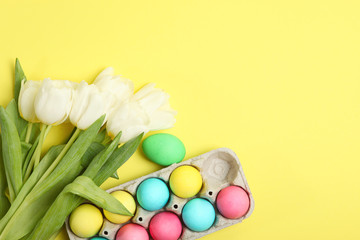 Easter eggs and flowers on the table top view. Easter composition with a place to insert text.