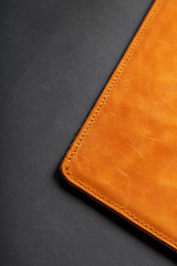 The album cover is made of brown genuine leather, handmade on a black background. Elements of a leather product close-up.
