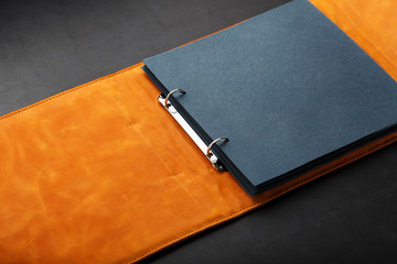 Photo album with blank black for photos. Split rings for close-up macro albums.The album cover is made of brown handmade genuine leather on a black background.