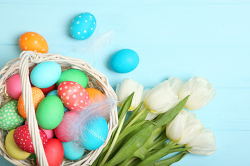 Easter eggs and flowers on the table top view. Easter composition with a place to insert text.