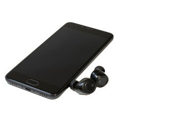 Isolate on white background smartphone and bluetooth headphones. Information Technology. Computer...