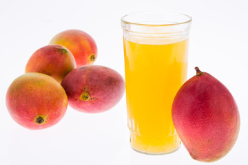 Mangoes with mango juice in a glass vase on white background.