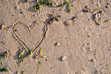  drawing of a heart in the sand on the beach with copy space