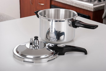 Double valve pressure cooker on white background.
