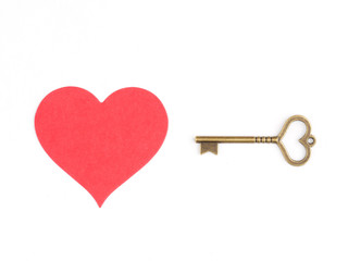 Image of a heart and a vintage key isolated on a white. Love relationship concept