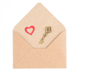 Image of a heart and a vintage key on a craft envelope isolated on a white