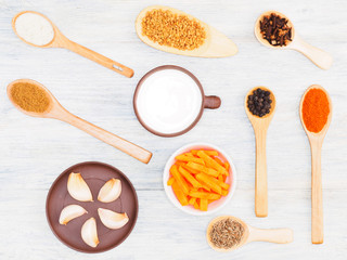 Spices, vegetables and herbs for cooking: salt, masala, cumin (jeera), chili, masala, bay leaves, garlic, carrot, fenugreek, cloves, yogurt, turmeric. Healthy eating concept
