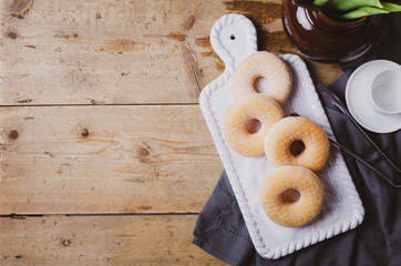 Doughnuts donut with sugar on wooden table.