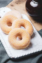 Doughnuts donut with sugar on wooden table.