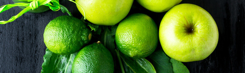 Banner of Green smoothie near ingredients for it on black wooden background