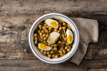 Chickpea stew with spinach and cod or potaje de vigilia top view. Typical spanish food for Easter holidays.