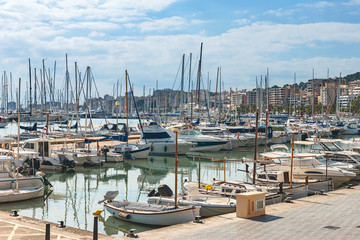small sailboats in the quiet harbor of the port of the Spanish city of Palma de Mallorca