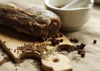raw meat with spices on a wooden board