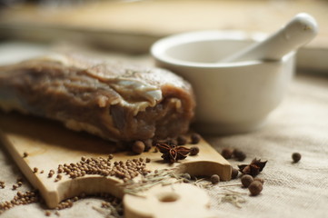raw meat with spices on a wooden board