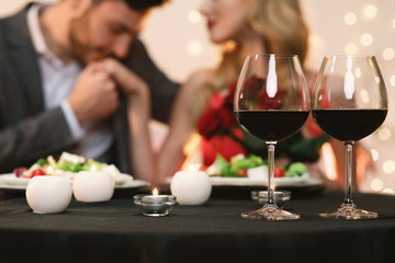 Loving couple in restaurant celebrating Valentine's day together