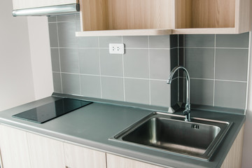 modern small home kitchen or cooking space in condominium clean new