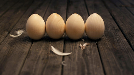Happy Easter! Wooden eggs on a wooden background. Minimal easter concept. Easter card with copy space for text. Top view, flatlay.