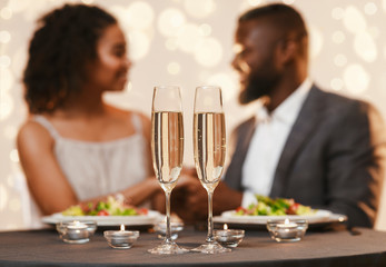 Two glasses of champagne on festive dinner table