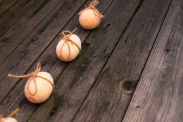 Happy Easter! Wooden eggs on a wooden background. Minimal easter concept. Easter card with copy space for text. Top view, flatlay.