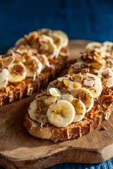 Slices of bread topped with peanut butter, honey and banana slices