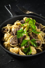 Italian pasta shells with beef sauce.