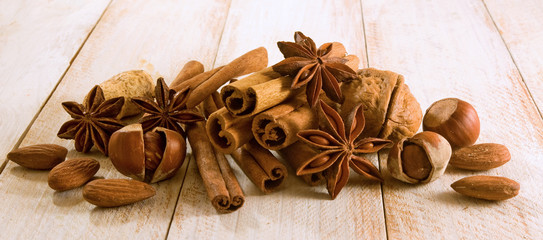 image of anise, cinnamon, almond nut, orange slices on the table