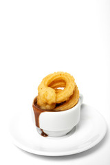 Cup of chocolate sauce with churros