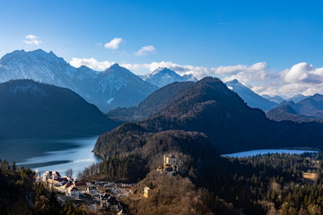 Panorama view of the Bavarian Alps and Lake with the famous Hohenschwangau Castle and Alpsee lake, Schwansee lake in winter