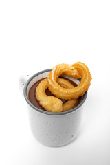 Cup of chocolate sauce with churros