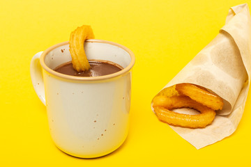 Cup of chocolate sauce with churros